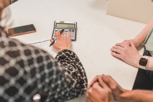 Koppel berekent annuïtaire hypotheeklasten met laptop, notities en rekenvoorbeeld aan de keukentafel